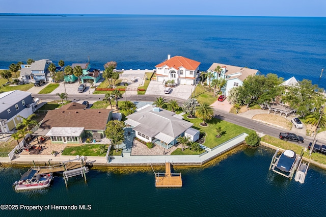 aerial perspective of suburban area with a nearby body of water