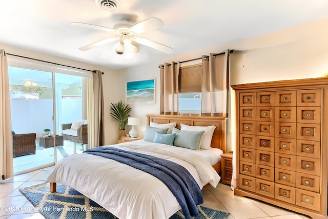 bedroom featuring access to exterior, light tile patterned flooring, and a ceiling fan