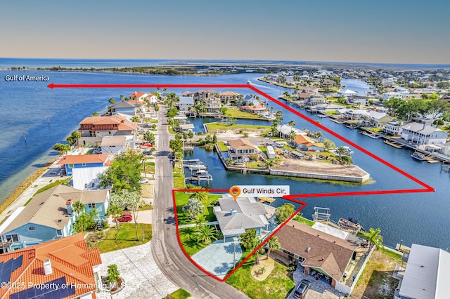 aerial view of residential area featuring a large body of water and property parcel outlined