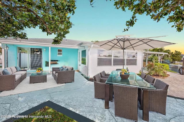patio terrace at dusk with an outdoor hangout area and outdoor dining area