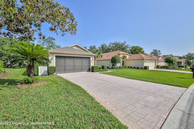 single story home featuring a front yard, stucco siding, and driveway