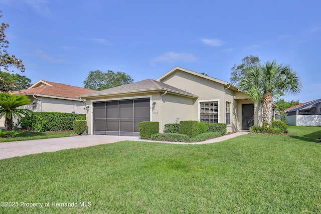ranch-style home featuring concrete driveway, a garage, stucco siding, and a front yard