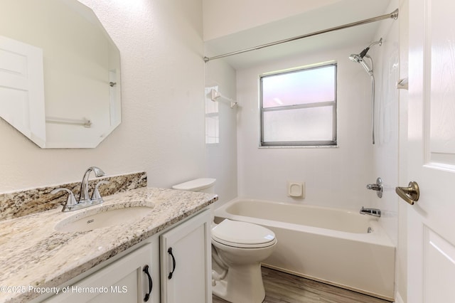 bathroom with shower / tub combination, wood finished floors, vanity, and toilet
