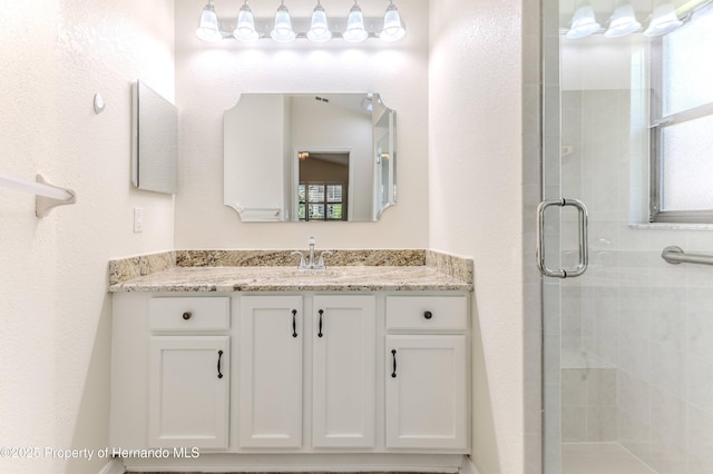 bathroom featuring a stall shower and vanity