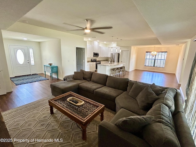 15585 Rene Ct, Brooksville, FL 34604 - living room with dark wood finished floors, healthy amount of natural light, a ceiling fan, a chandelier, and recessed lighting