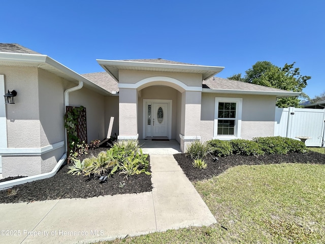 15585 Rene Ct, Brooksville, FL 34604 - entrance to property with stucco siding and a shingled roof
