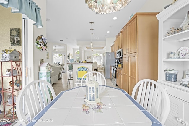 dining area featuring a chandelier and recessed lighting
