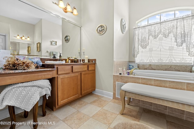 full bathroom featuring vanity, a towering ceiling, baseboards, and a bath