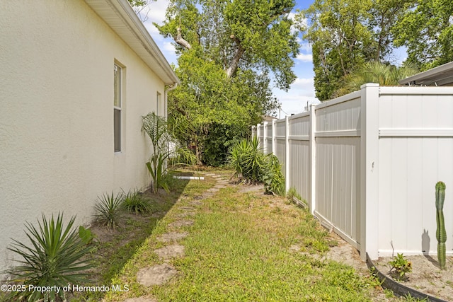 view of yard with fence and a gate