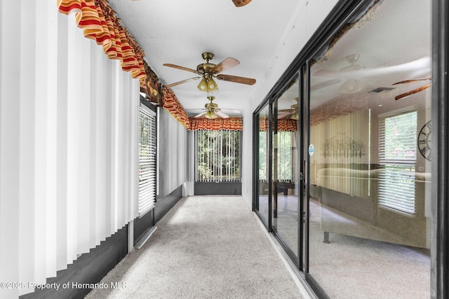 unfurnished sunroom with carpet
