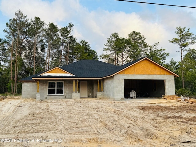 property in mid-construction with concrete block siding, a garage, and roof with shingles