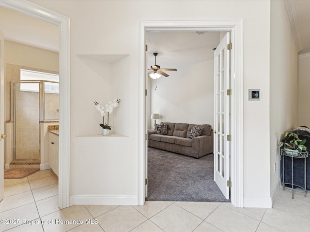 hall featuring light tile patterned floors and light colored carpet
