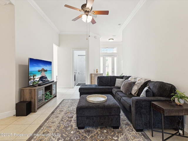 living room featuring ornamental molding, ceiling fan, baseboards, and light tile patterned floors