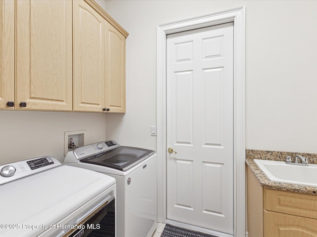 washroom featuring separate washer and dryer and cabinet space