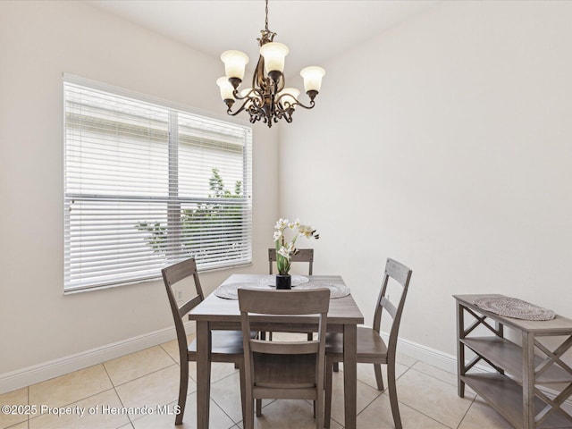 dining area featuring a chandelier, baseboards, and light tile patterned floors