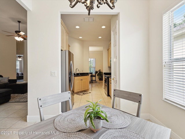 dining space with light tile patterned flooring, a chandelier, a ceiling fan, baseboards, and recessed lighting