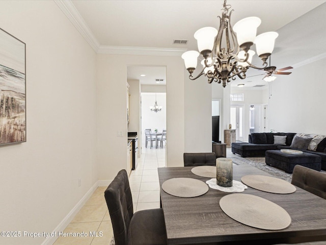 dining area with a chandelier, light tile patterned floors, crown molding, a ceiling fan, and baseboards