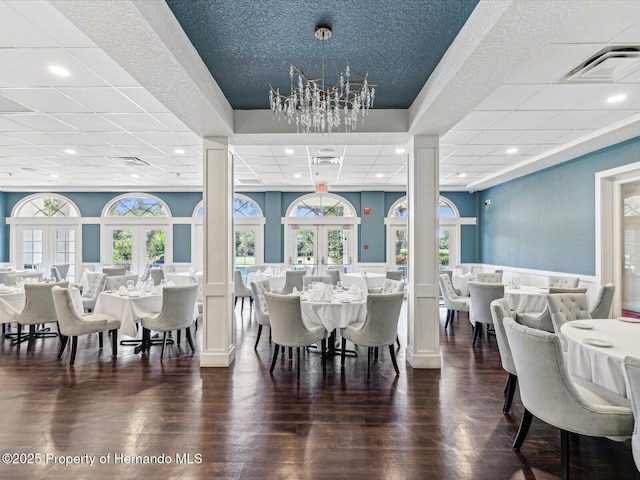 dining area with a paneled ceiling, recessed lighting, a wainscoted wall, decorative columns, and healthy amount of natural light
