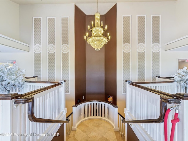 stairway with a chandelier and baseboards