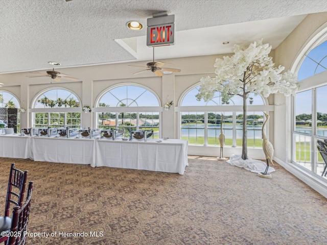 unfurnished sunroom featuring a water view