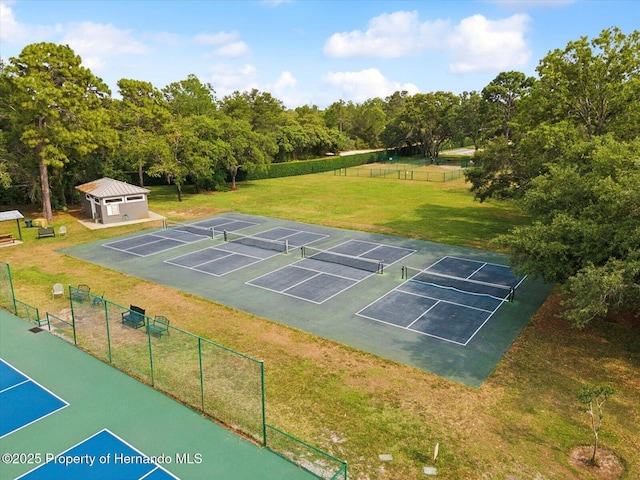 view of property's community with a tennis court and uncovered parking