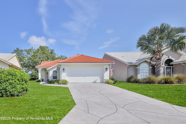 mediterranean / spanish-style house featuring an attached garage, a tiled roof, a front yard, and stucco siding