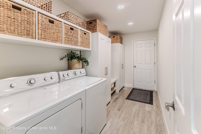 laundry room featuring washing machine and clothes dryer, light wood-type flooring, cabinet space, baseboards, and recessed lighting