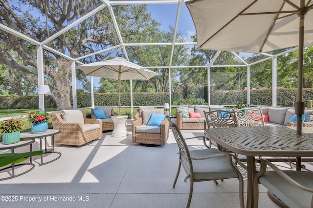 view of patio featuring outdoor lounge area and glass enclosure