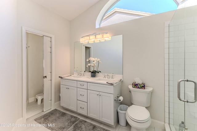 full bath with toilet, a stall shower, and double vanity