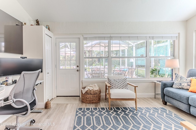 office featuring light wood-type flooring and baseboards