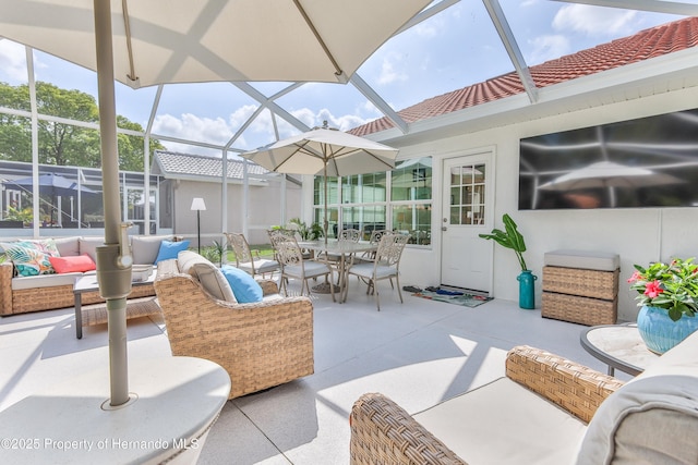 sunroom featuring outdoor dining space and an outdoor living space