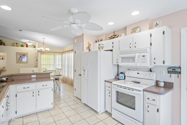 12271 House Finch Rd, Weeki Wachee, FL 34614 - kitchen with white appliances, white cabinets, tasteful backsplash, a chandelier, and lofted ceiling