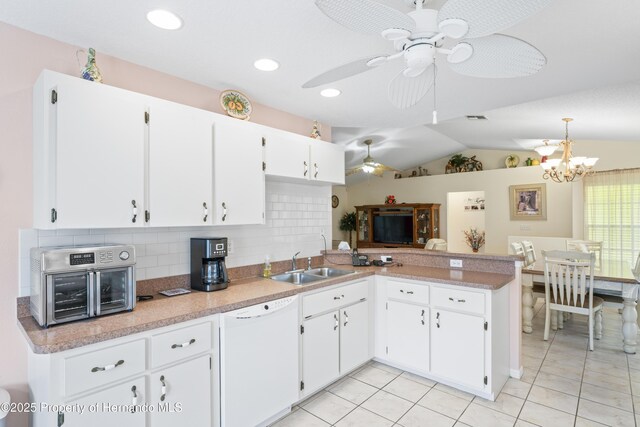 12271 House Finch Rd, Weeki Wachee, FL 34614 - kitchen with white dishwasher, a sink, tasteful backsplash, ceiling fan, and a chandelier