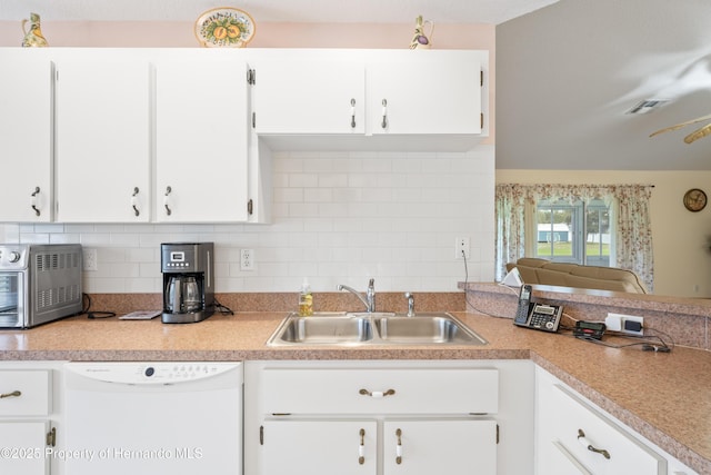 12271 House Finch Rd, Weeki Wachee, FL 34614 - kitchen featuring dishwasher, a sink, backsplash, and light countertops