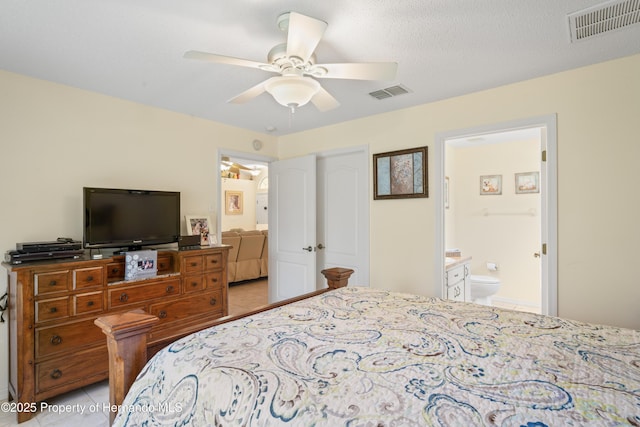 12271 House Finch Rd, Weeki Wachee, FL 34614 - bedroom with ensuite bath, light tile patterned floors, and a ceiling fan
