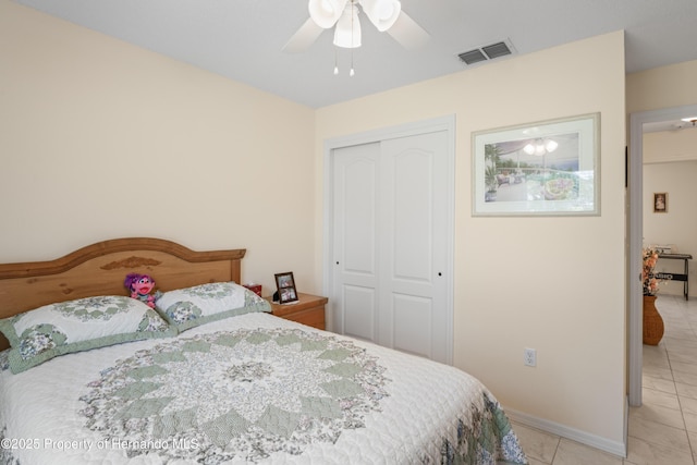 12271 House Finch Rd, Weeki Wachee, FL 34614 - bedroom featuring a closet, baseboards, light tile patterned flooring, and a ceiling fan