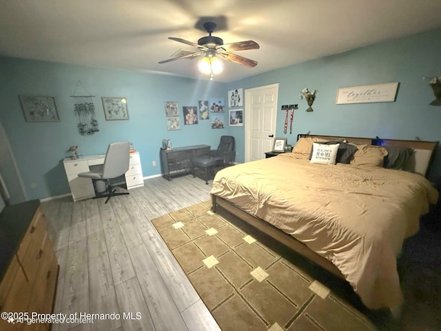 11080 Jackdaw Rd, Weeki Wachee, FL 34613 - bedroom featuring wood finished floors, ceiling fan, baseboards, and a desk