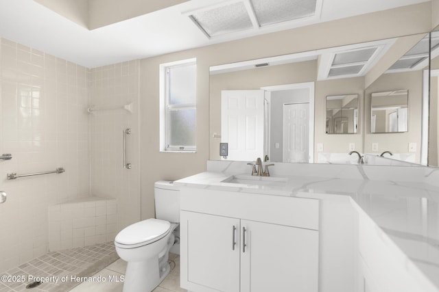 full bath featuring toilet, a tile shower, tile patterned floors, and double vanity