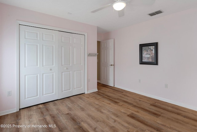 unfurnished bedroom featuring light wood finished floors and baseboards