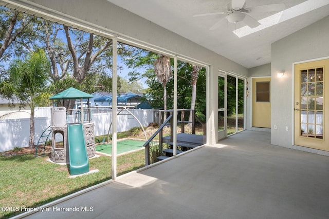 unfurnished sunroom featuring a ceiling fan and lofted ceiling