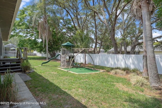 view of yard with a putting green and a playground