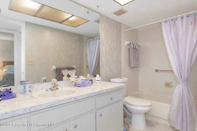 full bathroom with vanity, toilet, tile patterned floors, and shower / bath combo