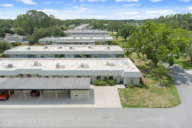 drone / aerial view of a tree filled landscape