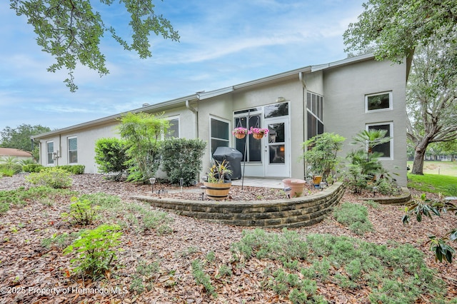 11750 Teapot Ct, Spring Hill, FL 34609 - back of house featuring stucco siding