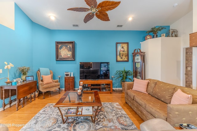 11750 Teapot Ct, Spring Hill, FL 34609 - living area with wood finished floors, a ceiling fan, and baseboards