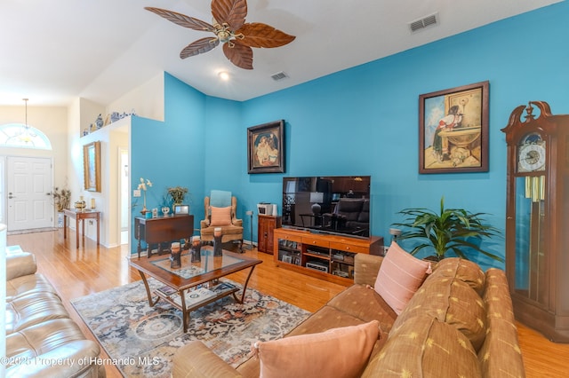 11750 Teapot Ct, Spring Hill, FL 34609 - living area featuring ceiling fan, wood finished floors, vaulted ceiling, and baseboards