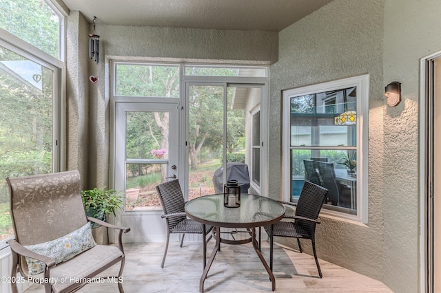11750 Teapot Ct, Spring Hill, FL 34609 - sunroom / solarium with a textured wall and wood finished floors