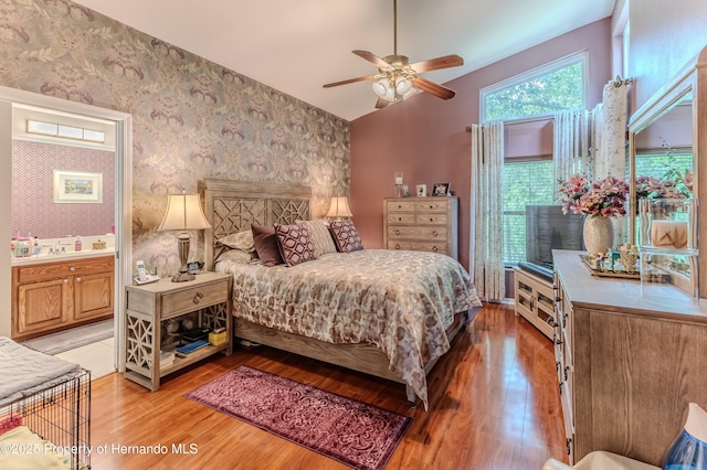 11750 Teapot Ct, Spring Hill, FL 34609 - bedroom featuring light wood-type flooring, wallpapered walls, vaulted ceiling, and ceiling fan