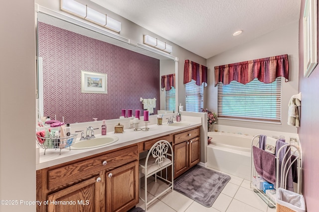 11750 Teapot Ct, Spring Hill, FL 34609 - bathroom with a textured ceiling, double vanity, a bath, tile patterned floors, and vaulted ceiling