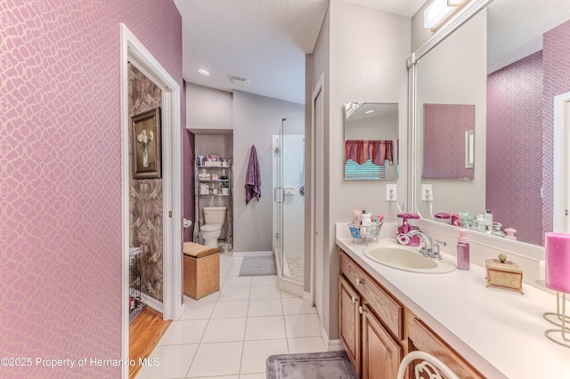 11750 Teapot Ct, Spring Hill, FL 34609 - bathroom with toilet, vanity, a stall shower, baseboards, and tile patterned floors
